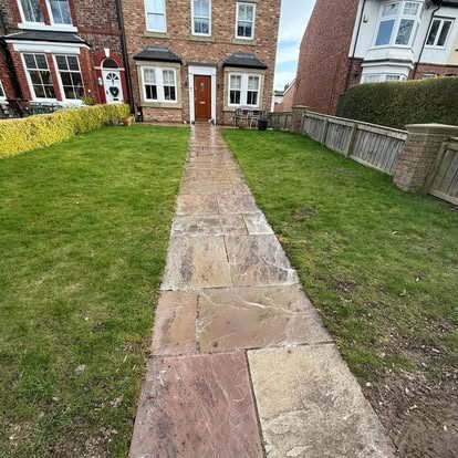 The same stone path after cleaning, lighter restored slabs